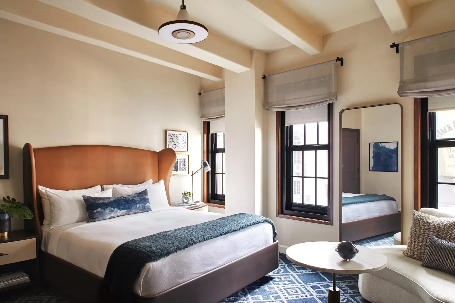 hotel bedroom with sofa, coffee table and large mirror