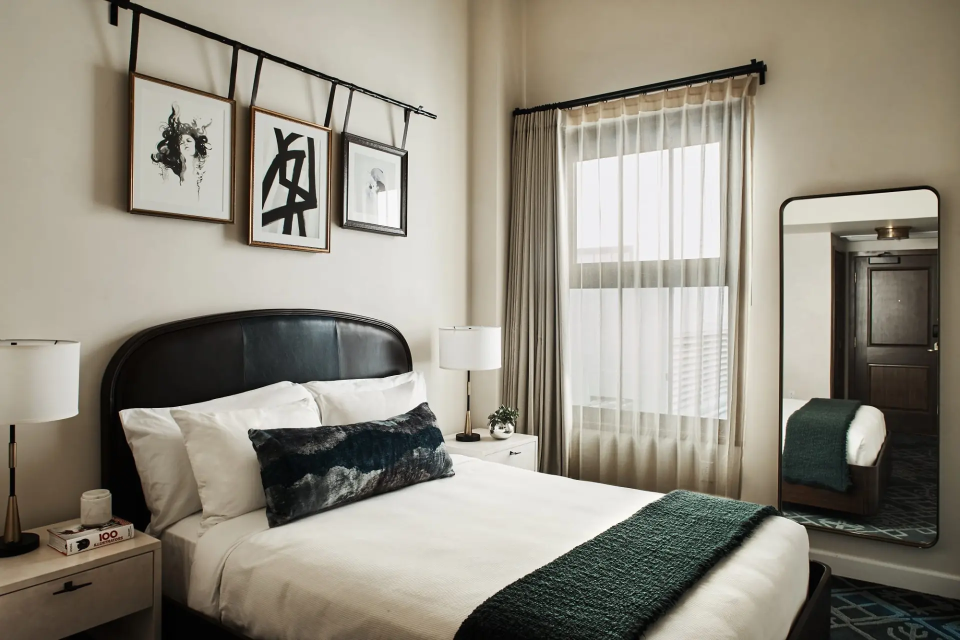 hotel bedroom with nightstands, large mirror and window