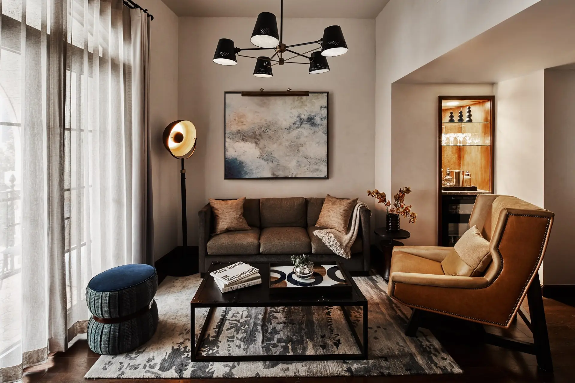 a living room with sofa, chair and coffee table