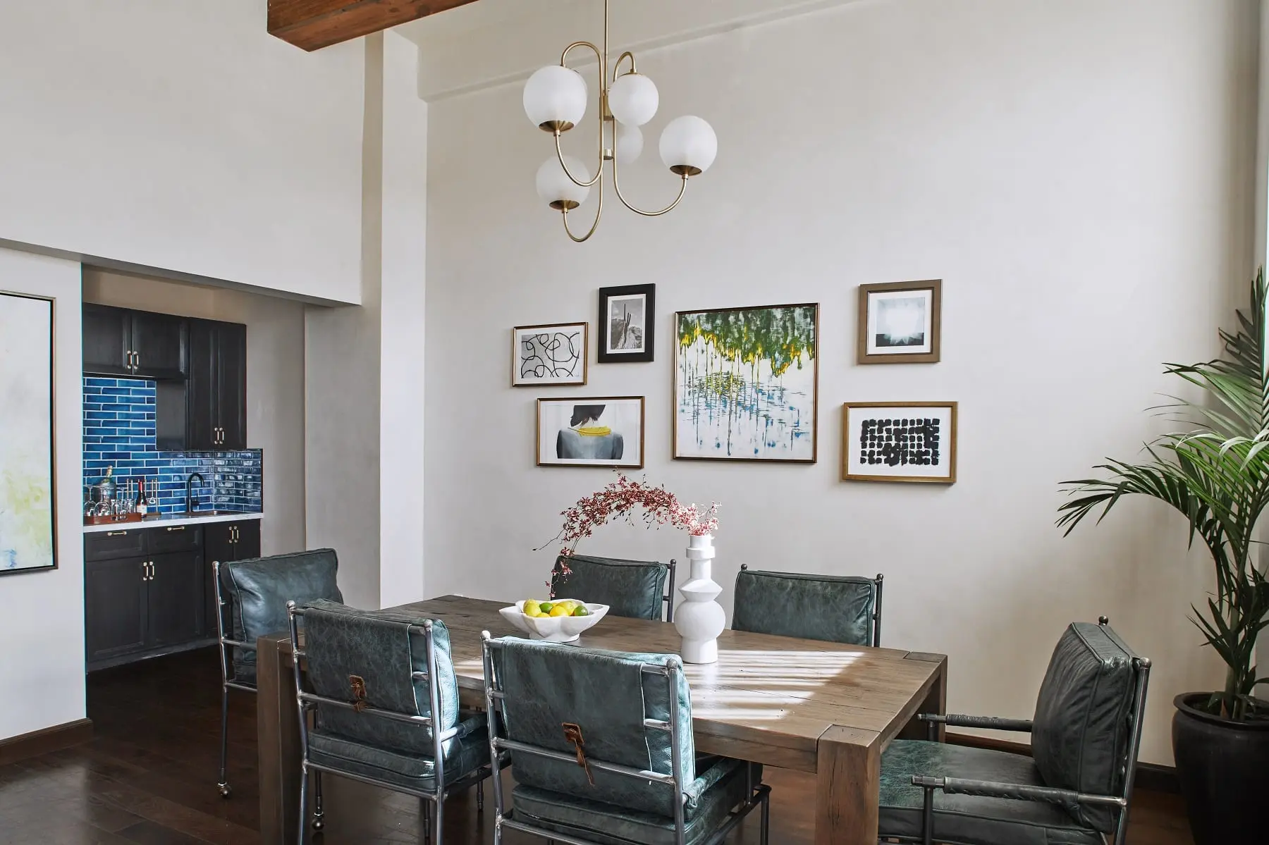 dining room with high ceiling, table with chairs and bar sink