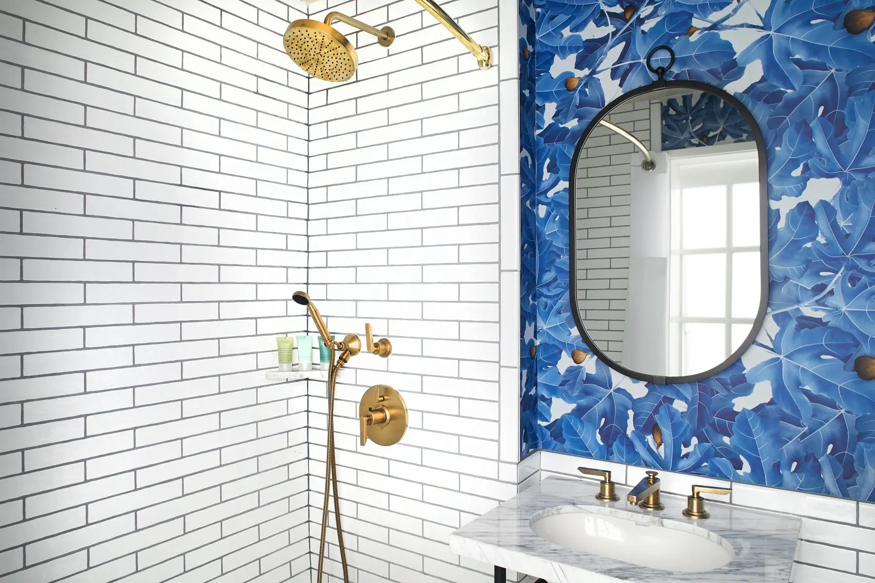 bathroom with sink and mirror next to a shower