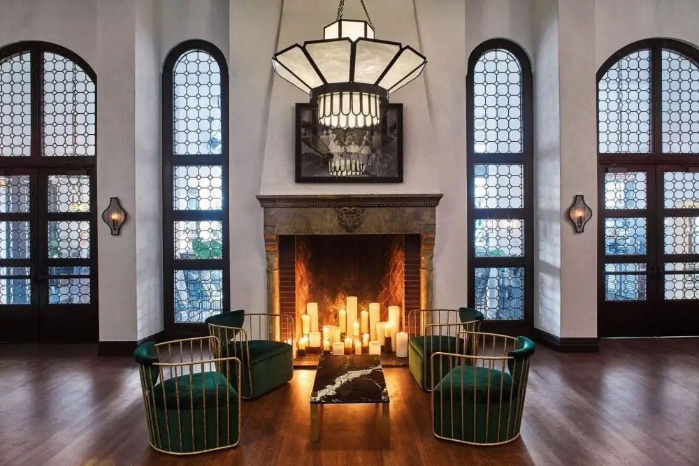 large hall with fireplace, chairs and coffee table