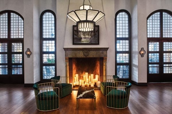 large hall with fireplace, chairs and coffee table