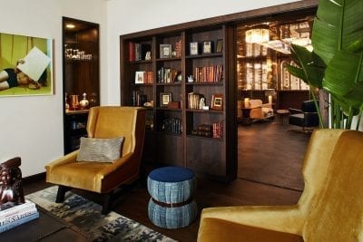 living room with rug, chairs, and bookcase