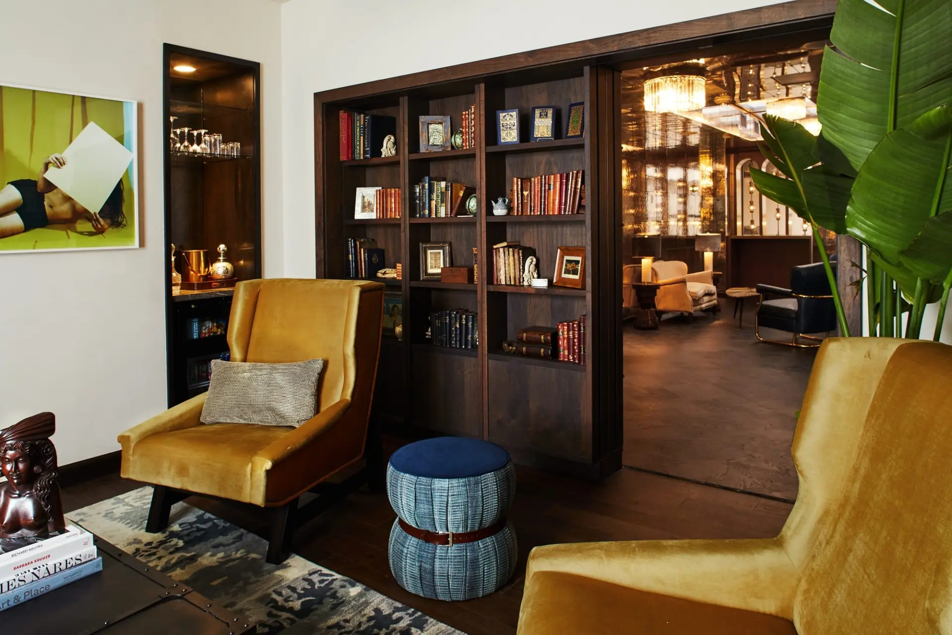 living room with rug, chairs, and bookcase