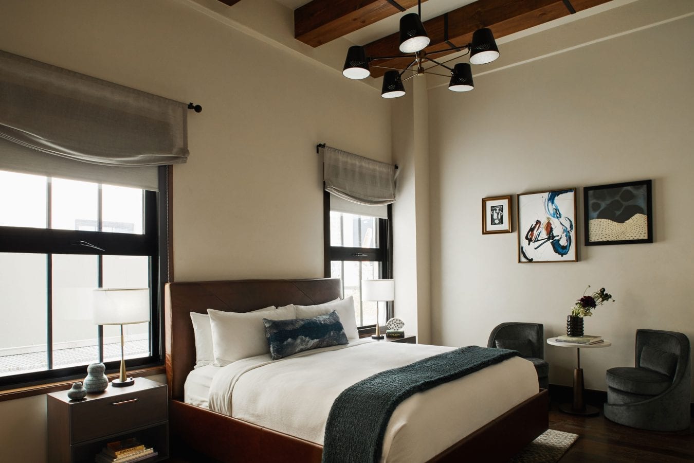 hotel room with bed, nightstands, chairs and a small table