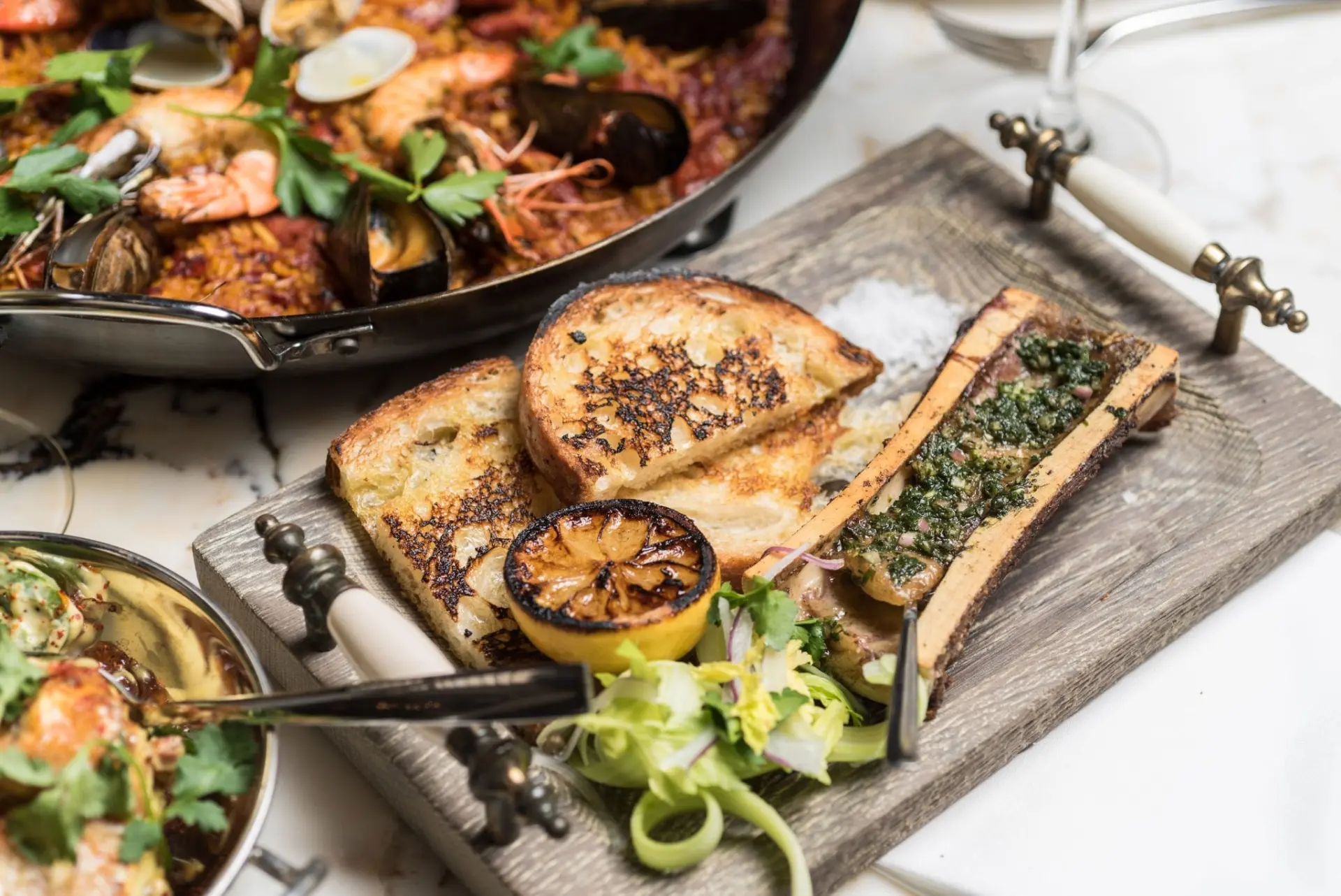 closeup of wooden plate with bone marrow and toasted bread