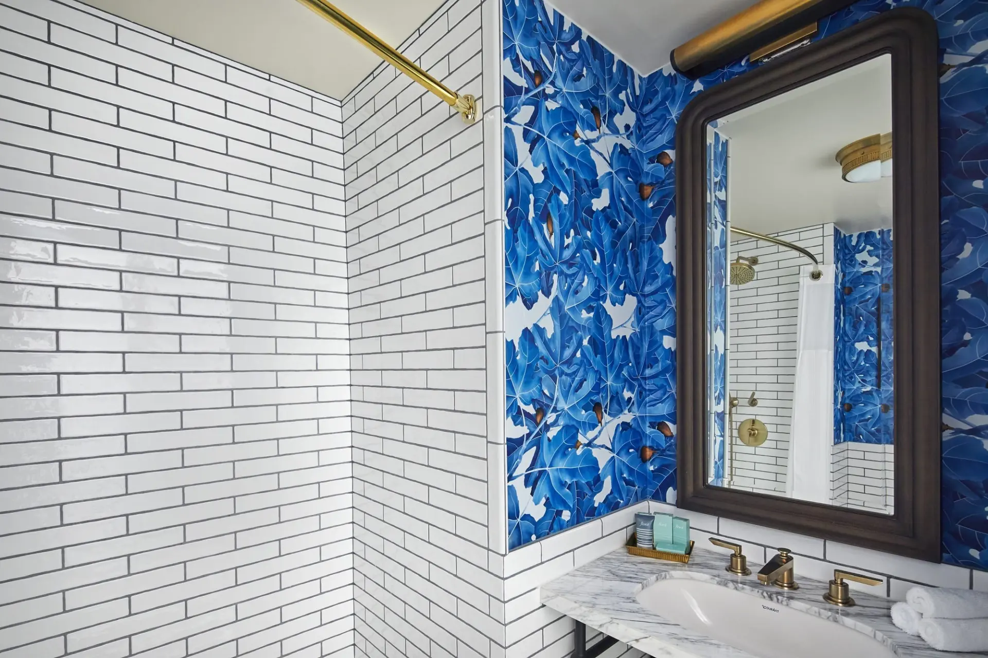 bathroom with a sink, shower and mirror