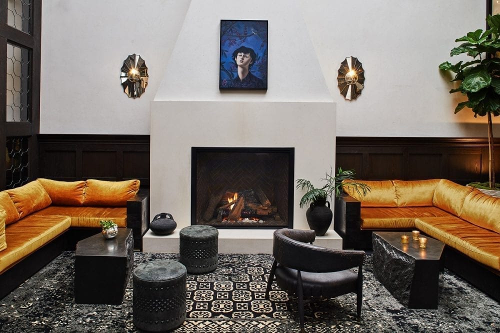 living room with large fireplace with sectional couches at each side, charis and coffee tables