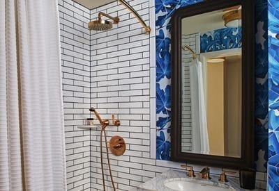 bathroom with sink and mirror next to a shower