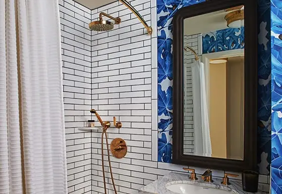 bathroom with sink and mirror next to a shower