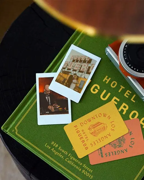 coasters, camera and photos on top of book