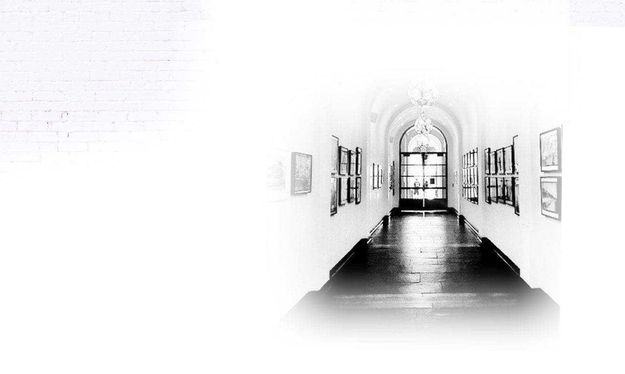 hallway with framed photos on walls