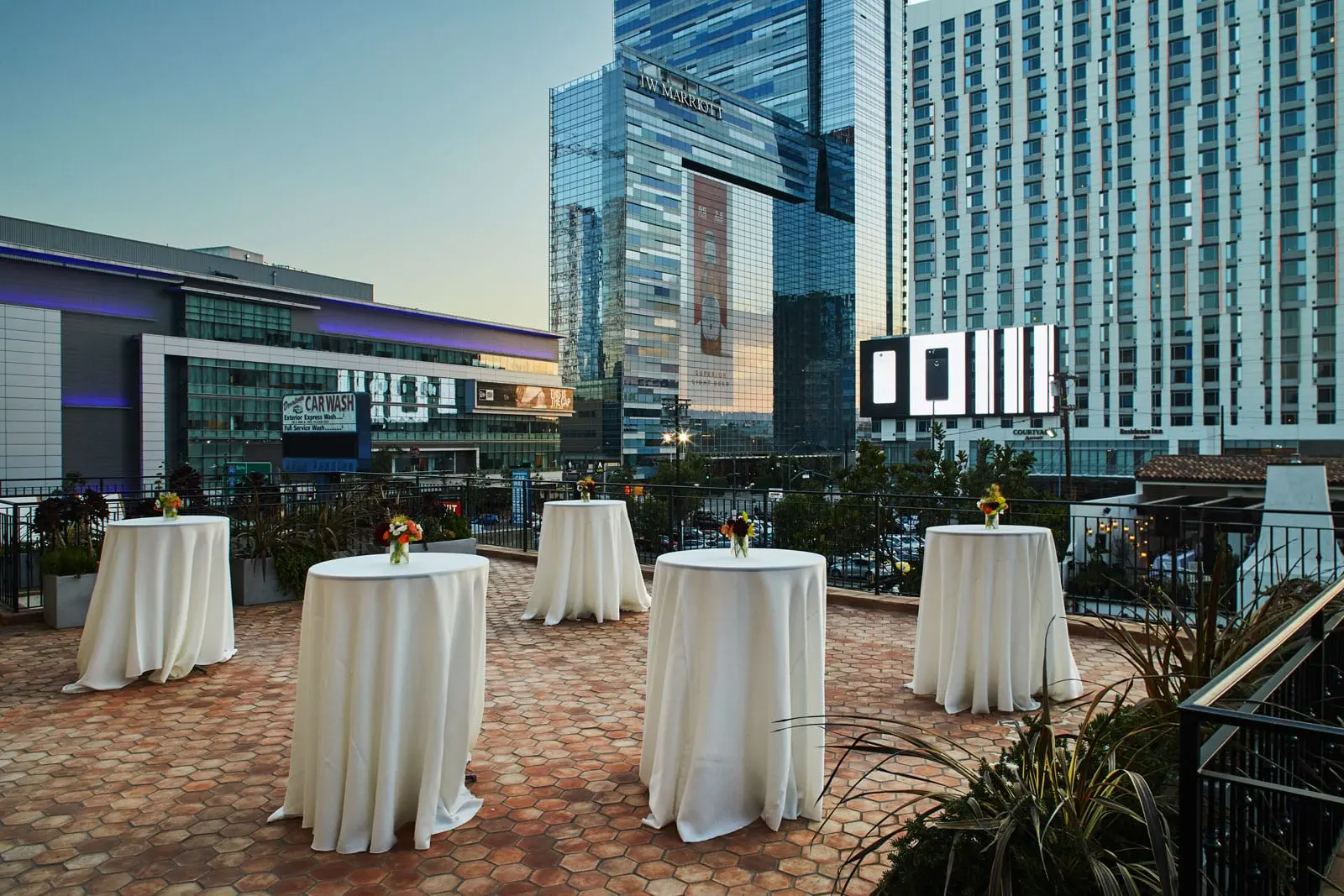 outdoor cocktail tables with buildings in background