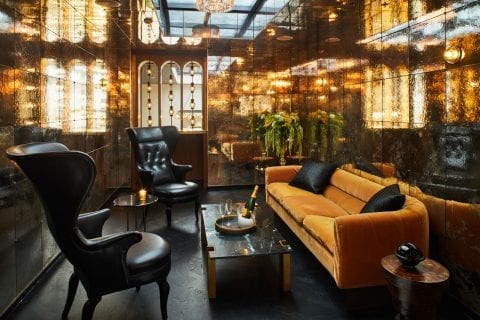 living room with sofa and high back leather chairs