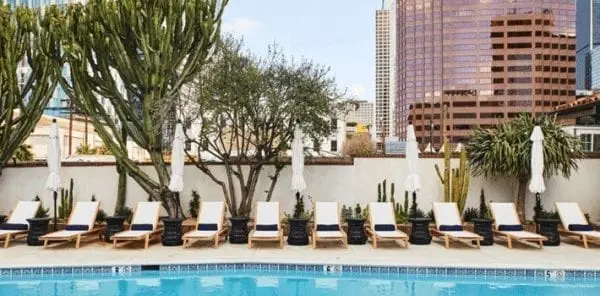 outdoor pool and row of empty lounge chairs