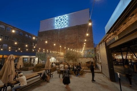 people walk around at night in the LA fashion district